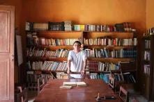 Cristian Sulub in front of a bookshelf