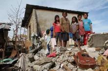 A Familiie front of her destroyed house