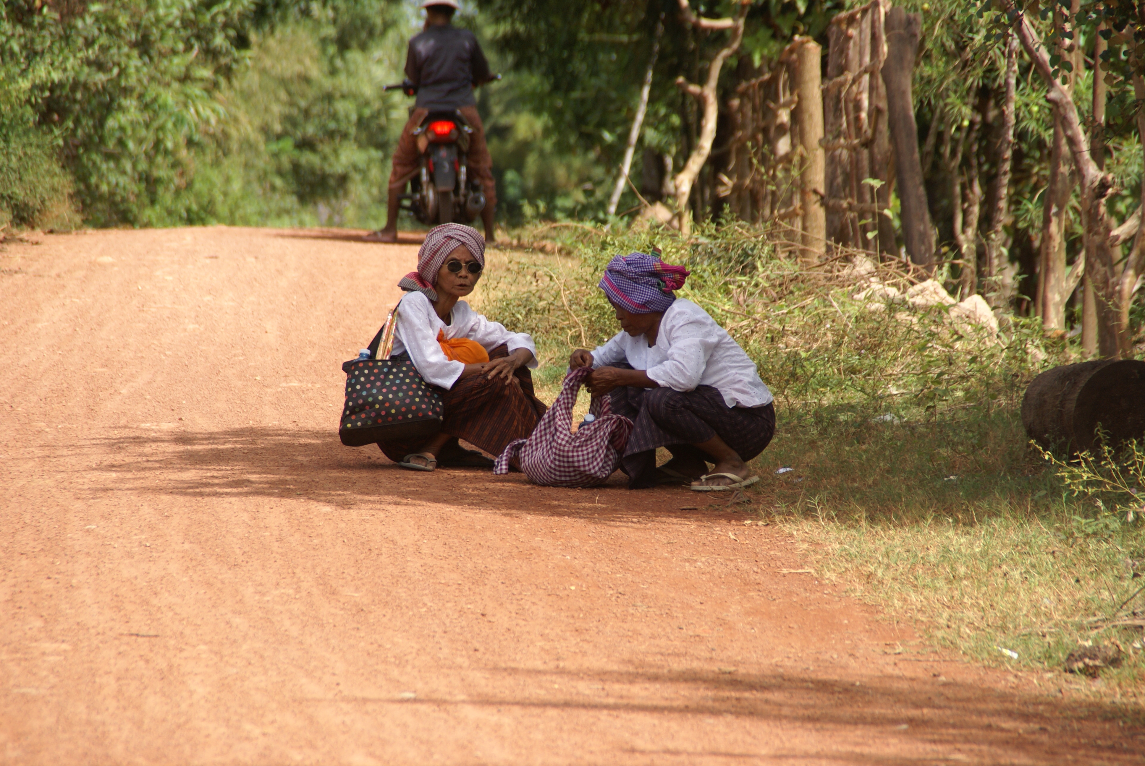 Two women in Cambodia CEDAW in Cambodia - Two women sitting at the side of a road in Cambodia