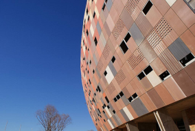 Fassade des Soccer City Stadion vor blauem Himmel