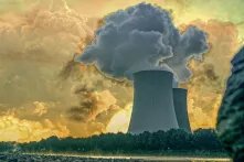 Illustration: Cooling tower of a nuclear power plant, with explosion at the horizon