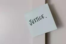 Sticky note with the word 'Justice' on it