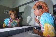 Abi Cris in front of big mirror with makeup