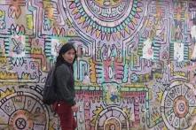 Yolanda Perez in front of painted wall