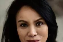 Portrait of Ana P. Santos. She is looking into the camera smiling.