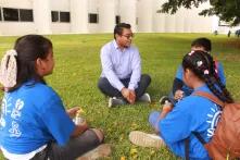 Cristian Sulub on a meadow with young people