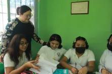 Gladys Pinto, with four student girls