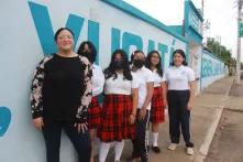 Gladys Pinto with student girls in the street