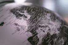 Grayscale photo of desk globe