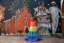In front of a big New Year's installation wrapped in rainbow flag