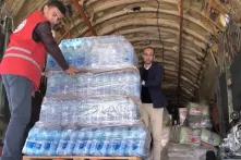 EGYPT - DECEMBER 22, 2023: Men unload humanitarian aid from an Ilyushin Il-76 strategic airlifter of Russia s Emergency Situations Ministry. A total of 17 Emercom flights have so far delivered some 390t of food, clothing, medical and other essential supplies to the Gaza Strip. Video screen grab.