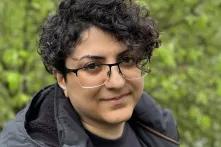 Portrait of Rezvaneh Mohammadi in front of a green background. 