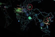 World map with lines and circles shows cyberattacks between regions, focused on Europe, Asia, and the USA.