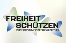 Text auf drei sternförmigen Farbflächen: "Freiheit schützen. Konferenz zur inneren Sicherheit"