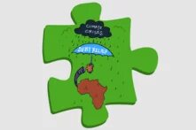 Illustration: Der afrikanische Kontinent hält einen "Schuldenerlass-Schirm" über sich, um die Klimakrise abzuwenden.