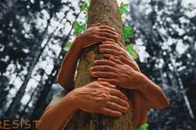 Several hands embrace a tree trunk; green leaves and the word "RESIST" appear, with the background forest shown in black and white.