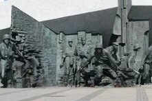 Ein Denkmal zeigt mehrere Soldaten, die aus verwinkelten Mauerresten stürmen