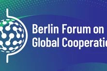 Illustration: Text "Berlin Forum on Global Cooperation" with stylized globe on a blue-green background with dot pattern.