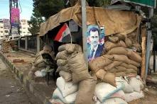Checkpoint mit einem Poster von Bashar al-Assad in Damaskus, Syrien