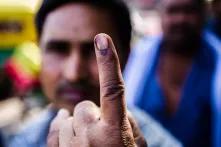 A voter displays his inked finger for a photograph after casting his vote at a polling station during the third phase of voting for national elections in New Delhi, India, on Thursday, April 10, 2014.