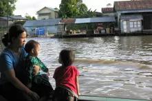 One Mother and two Children on an boat.