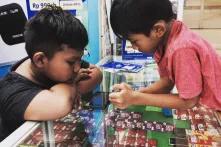 two boy are playing smartphone in Jakarta