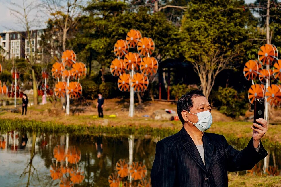 Asian man wearing mask on the phone