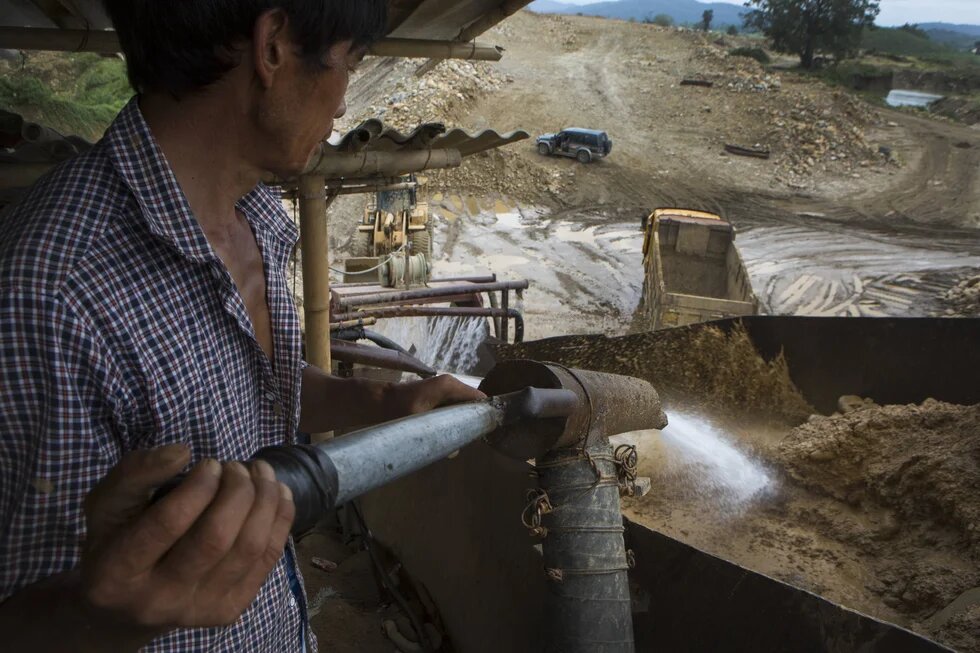The picture shows a man operating on a mining building in the Kachin state of Myanmar.