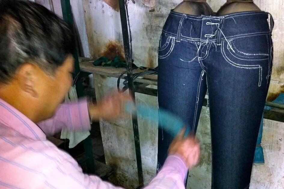 Jeans washing plant in Guangdong Textile worker washing a jeans