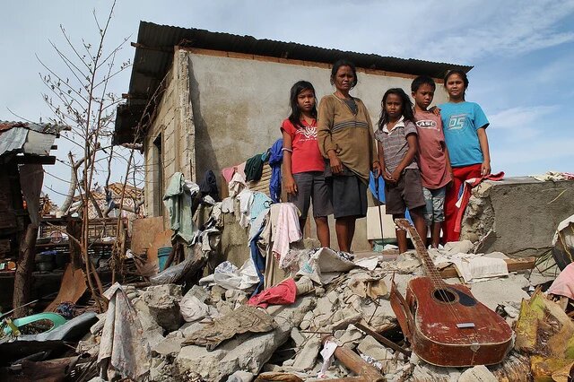 Philippines, November 2013 A Familiie front of her destroyed house