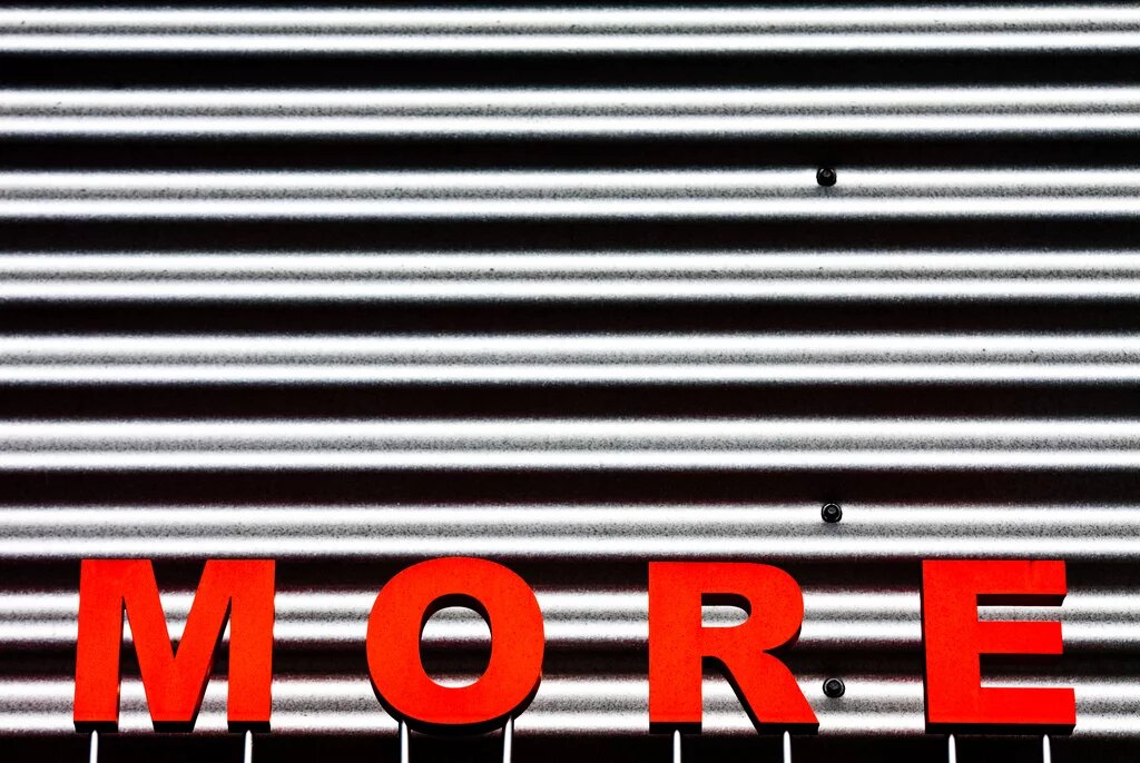 More A red sign saying the word "more"