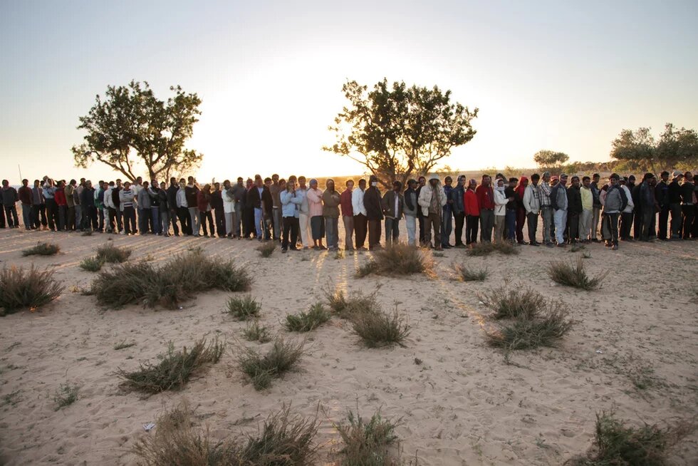 Refugees from Libya Queue for Food at Tunisia Transit Camp Hundreds of refugees from Libya line up for food at a transit camp near the Tunisia-Libya border.