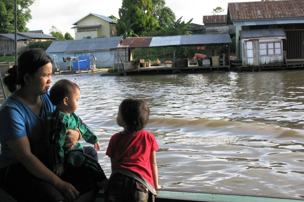 Der Mahakam in Kalimantan Timur, Indonesien Eine Mutter mit zwei Kindern auf einem Boot.