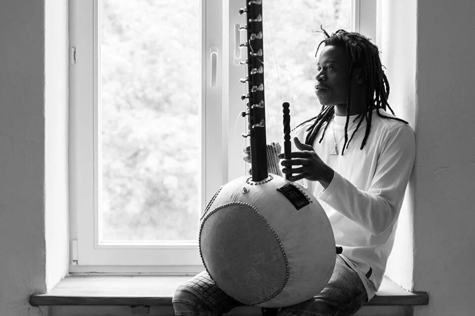 Der Musiker Buba Badjie Kuyateh Buba Badjie Kuyateh sitzt mit seinem Instrument am Fenster