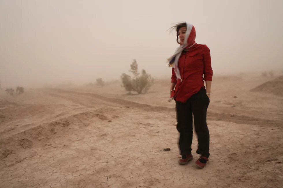 Eine Frau im Sandsturm in der Nähe der iranischen Stadt Meybod. Eine Frau im Sandsturm in der Nähe der iranischen Stadt Meybod.