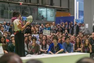 COP25 A girl speaking at COP25 in front of many young people