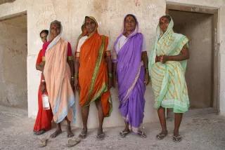 Women posing in front of a wall in India CEDAW in India - Photo: Women wearing colorful saree posing in front of a wall