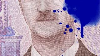 Syria - "Ten Years in a Parallel World" Graphic: Part of a Syrian banknote with ink stain
