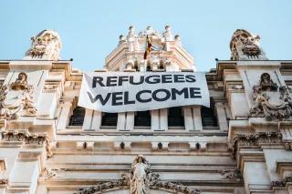 Ein Banner mit der Aufschrift "Refugees welcome" hängt am Rathaus von Madrid. Ein Banner mit der Aufschrift "Refugees welcome" hängt am Rathaus von Madrid.