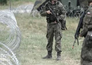 Polen-Soldaten an der Grenze. polnische Soldaten in der Nähe eines Zaunes an der Grenze Polen-Soldaten an der Grenze. polnische Soldaten in der Nähe eines Zaunes an der Grenze