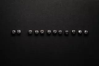 "No Homophobia" written in metal perls on black surface