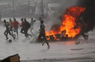 Protest in Zimbabwe People run at a protest as barricades burn during rainfall in Harare, Zimbabwe January 14
