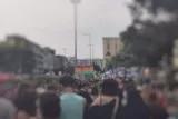 Eine Demonstration in Kreuzberg auf der eine Regenbogenfahne geschwungen wird