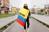Hooded man with banner "Resistencia" in the colors of the Colombian flag