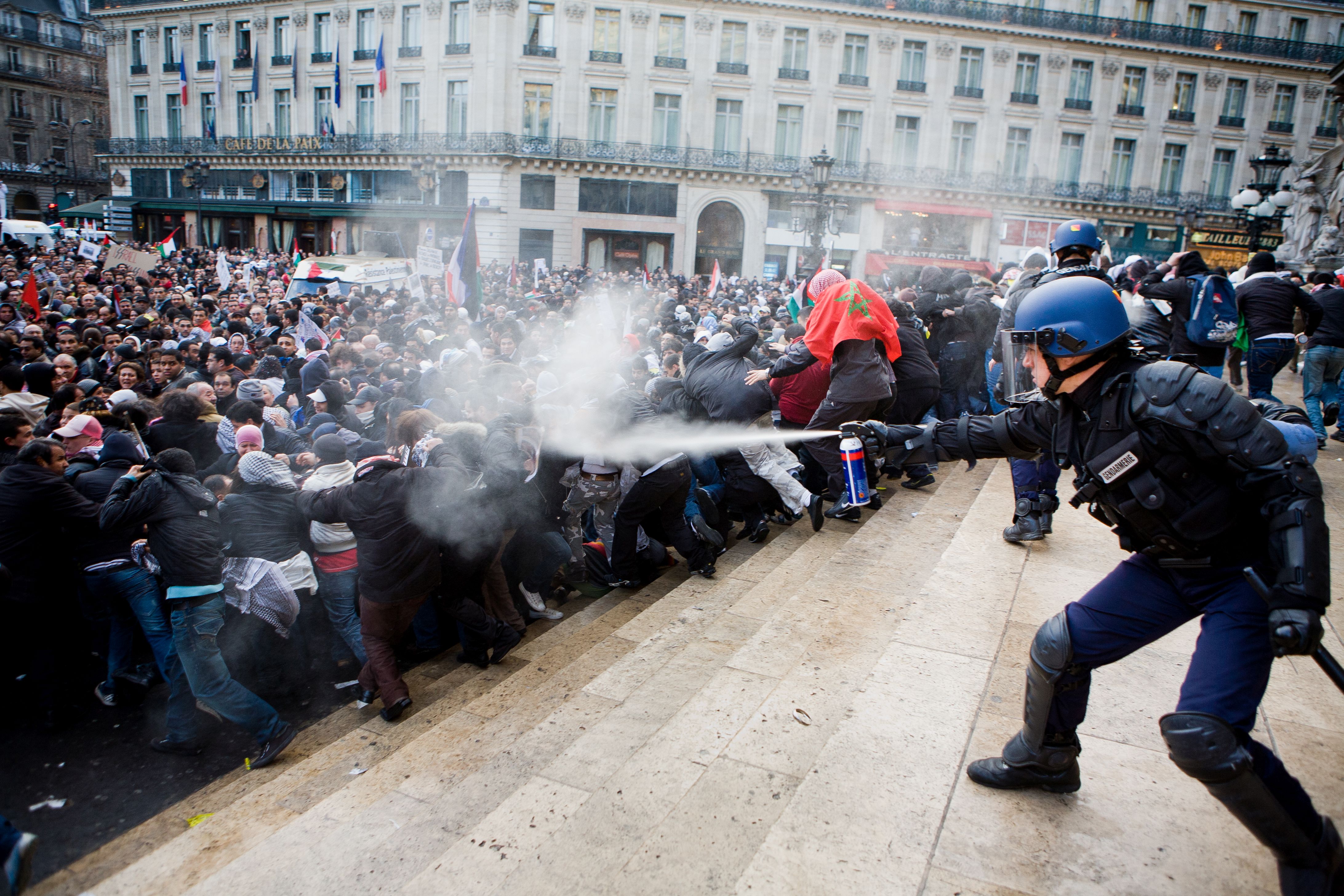 Riot Police assault on the Opera House Policeman uses pepper spray against protesters in France
