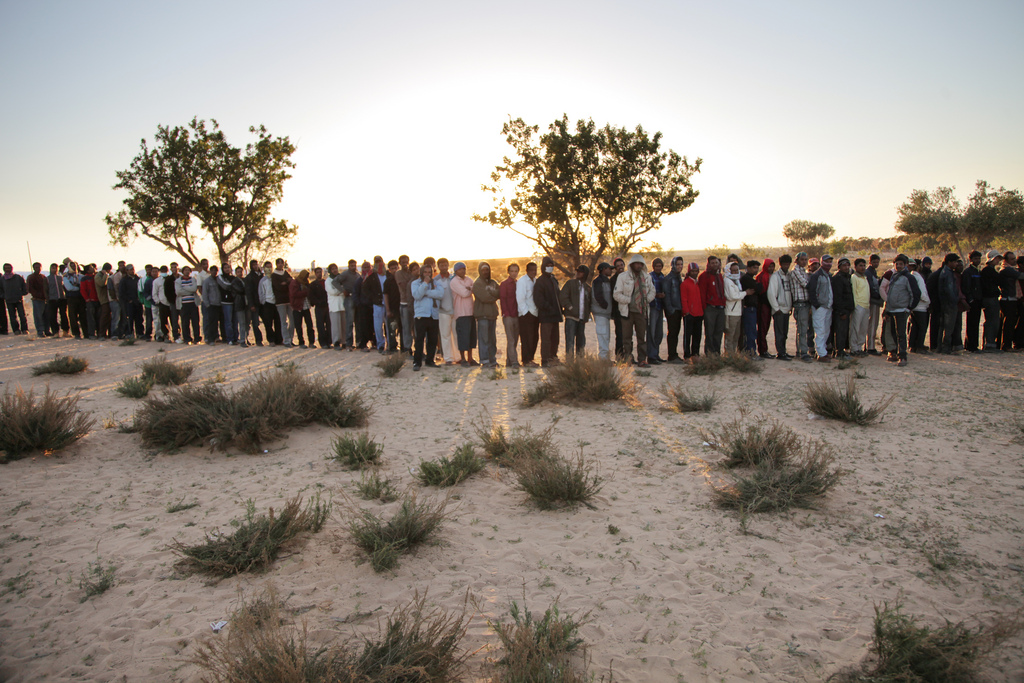 Refugees from Libya Queue for Food at Tunisia Transit Camp Hundreds of refugees from Libya line up for food at a transit camp near the Tunisia-Libya border.